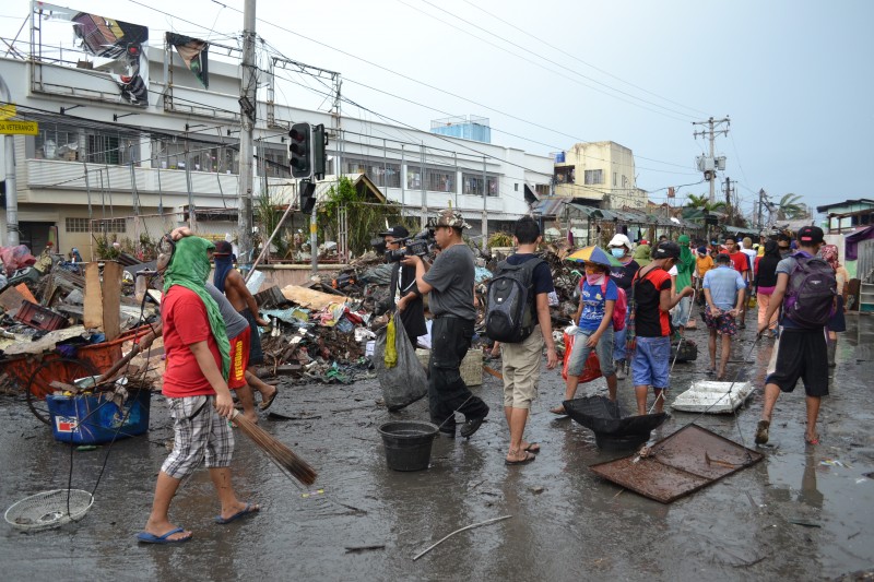 Residents come out in droves to clean the streets of Tacloban as part of the cash-for-work program. PHOTO BY KRISTINE SABILLO/INQUIRER.net