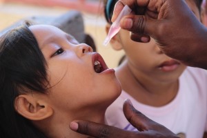 A child receives oral polio vaccine during a mass immunization campaign in Tanauan, Leyte, four weeks after Typhoon Yolanda hit the area. UNICEF PHOTO