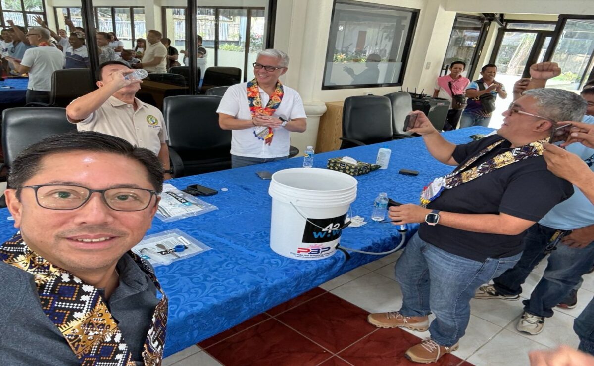 Carmen Mayor Leony Bahague, together with Davao del Norte congressional candidate JM Lagdameo, PBP Partylist nominees Atty. Goyo Larrazabal and Beaver Lopez, drinking the water sourced from rain water mixed with dirt and filtered by Waves for Water filtration system, which provides safe and clean drinking water.