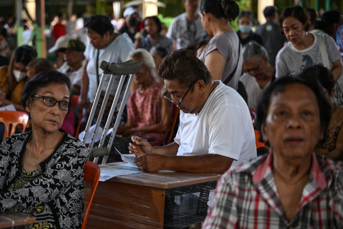 A man (C) votes at a polling station during mid-term elections in Manila on May 12, 2025.