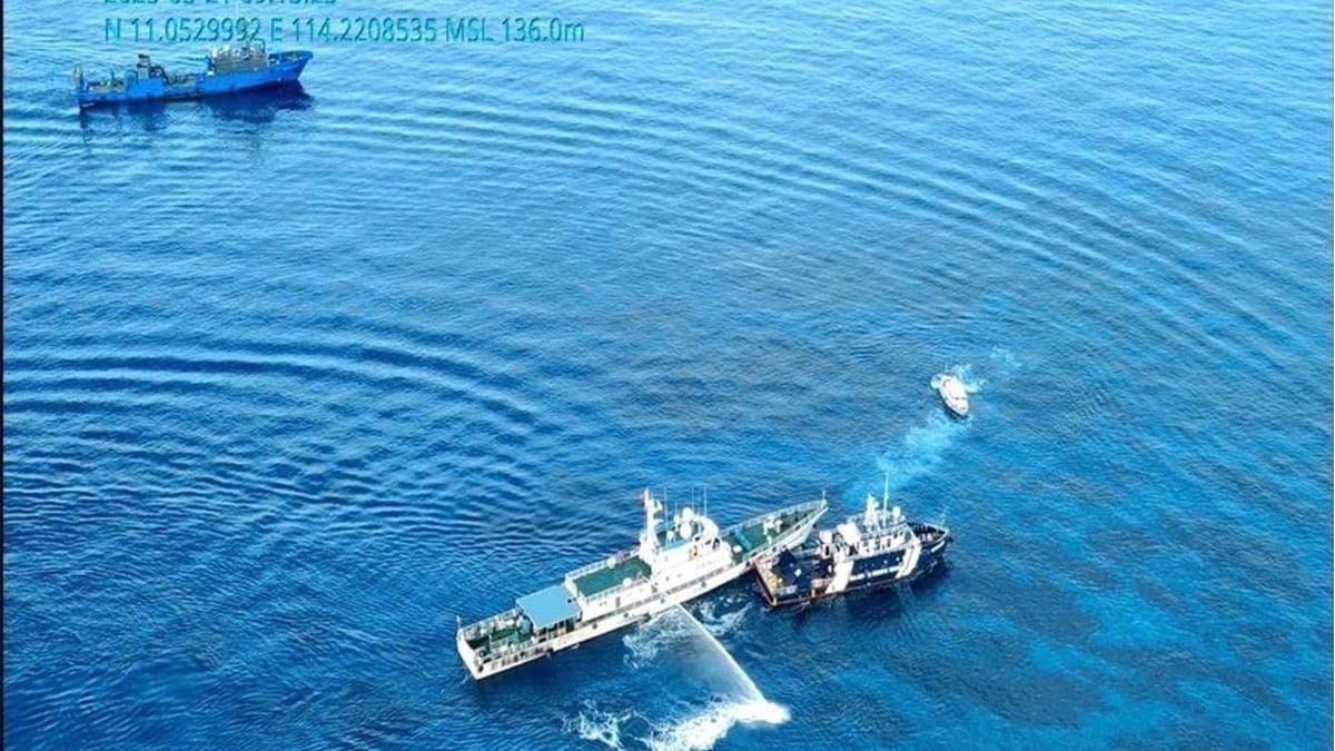 In this handout photo grabbed from video provided by the Philippine Coast Guard/Bureau of Fisheries and Aquatic Resources (PCG/BFAR), a Chinese Coast Guard ship, left, uses a water cannon and sideswipped a Philippine fisheries vessel on a research mission near one of three sandbars called Sandy Cay in the disputed South China Sea on Wednesday May 21, 2025. (PCG/BFAR via AP)