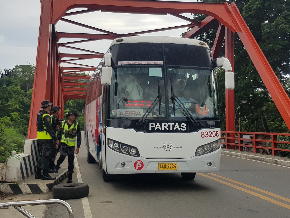 ROAD CHECK In this 2019 photo, police officers in Bangued,Abra, check a passenger bus as security measures were put in place during the election period that year.