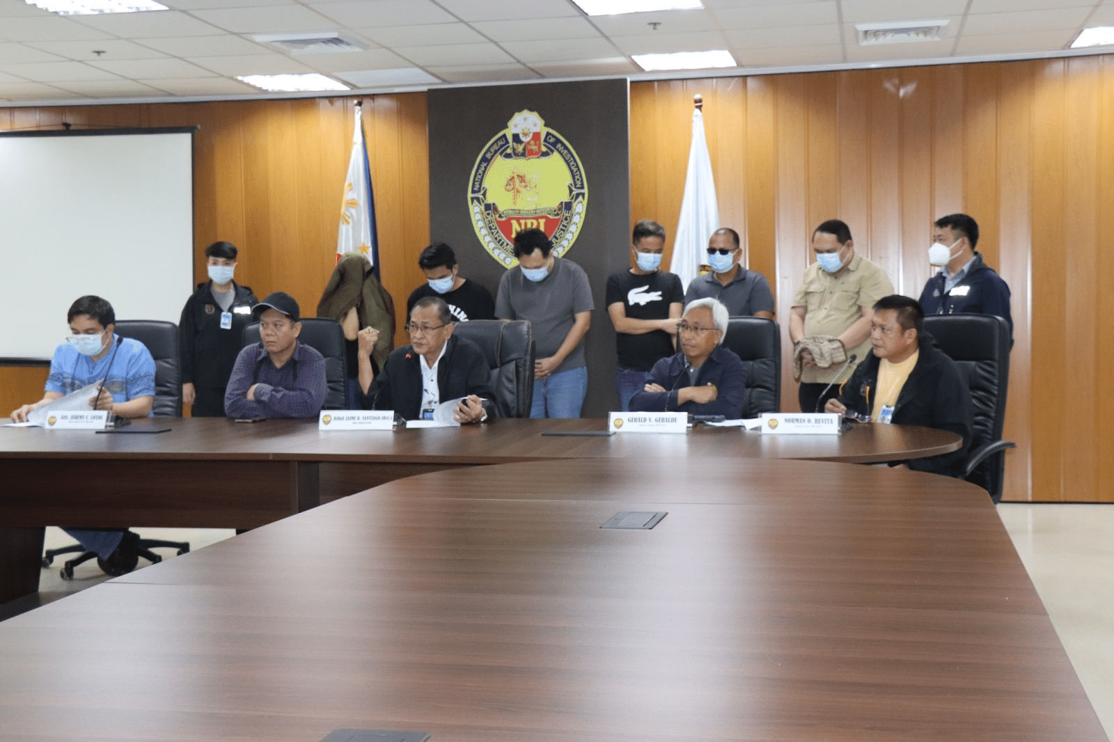 The National Bureau of Investigation presents to the media on Friday, May 9, the six individuals arrested for plotting to manipulate the automated counting machines supposedly to ensure the victory of a mayoral candidate. (Photo by the National Bureau of Investigation)
