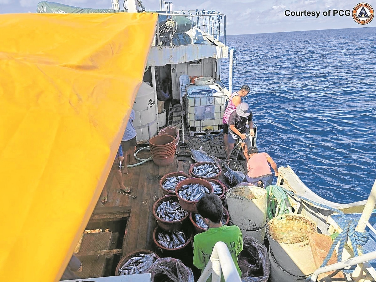 FLOATING KADIWA Fish caught in the West Philippine Sea areloaded onto the Philippine government-owned MV Mamalakaya, which purchased 20 tons of fish during its maiden voyage on May 9. The Philippine Coast Guard and the Bureau of Fisheries and Aquatic Resources launched the Kadiwa ng Bayaning Mangingisda Program to help Filipino fishermen.