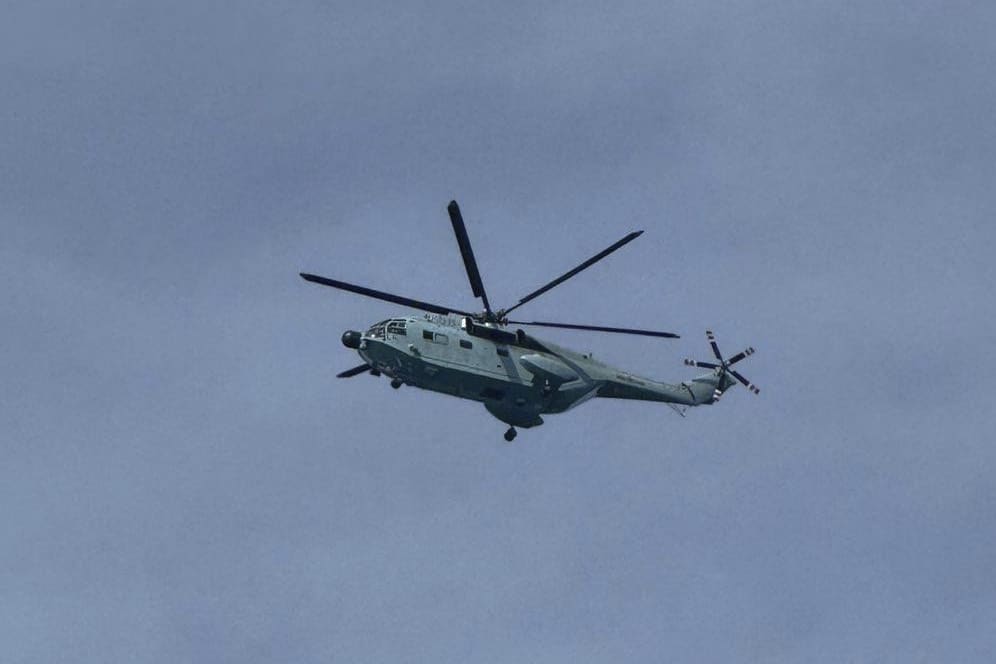 In this photo provided by the Armed Forces of the Philippines, Public Information Office (PAO), a Chinese helicopter flies over the long-grounded Philippine warship BRP Sierra Madre in the vicinity of Second Thomas Shoal at the disputed South China Sea on Wednesday August 20, 2025. (Armed Forces of the Philippines PAO via AP)