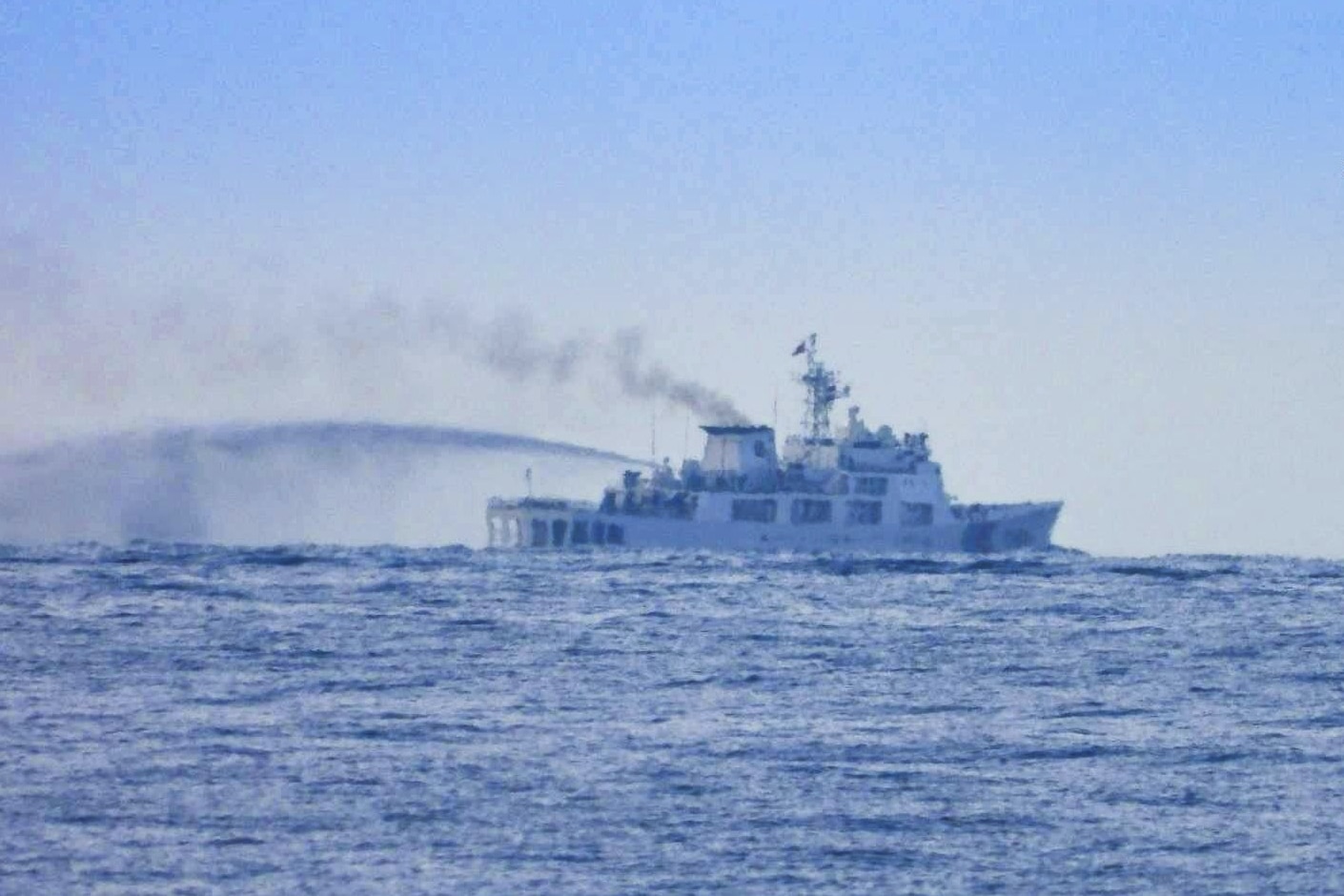 In this photo provided by the Armed Forces of the Philippines, Public Information Office (PAO), a China Coast Guard Vessel conducts apparent water cannon drill close to long-grounded Philippine warship BRP Sierra Madre in the vicinity of Second Thomas Shoal at the disputed South China Sea on Wednesday August 20, 2025. (Armed Forces of the Philippines PAO via AP)