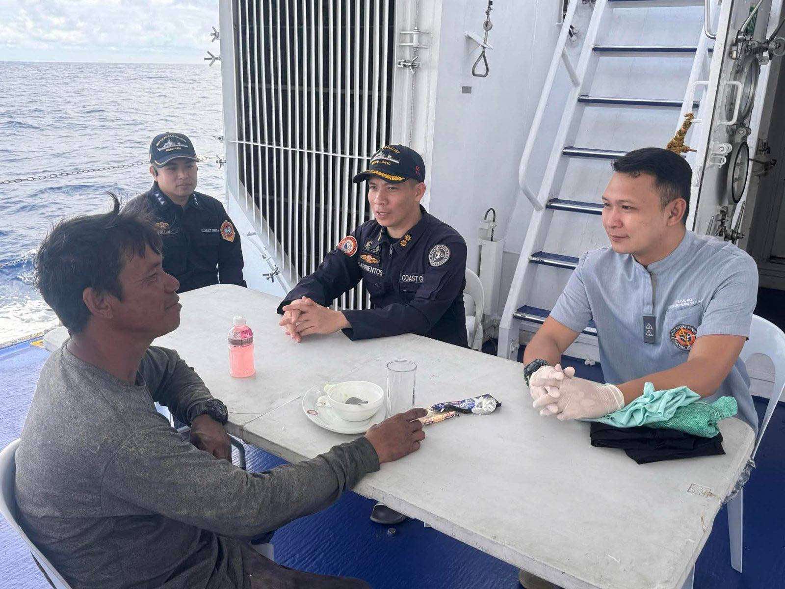 CAPTION: Crew of BRP Cape San Agustin interacts with fisherfolk Larry Tumalis who was rescued by the Philippine Coast Guard on Dec. 25, 2025. PHOTO FROM THE PCG