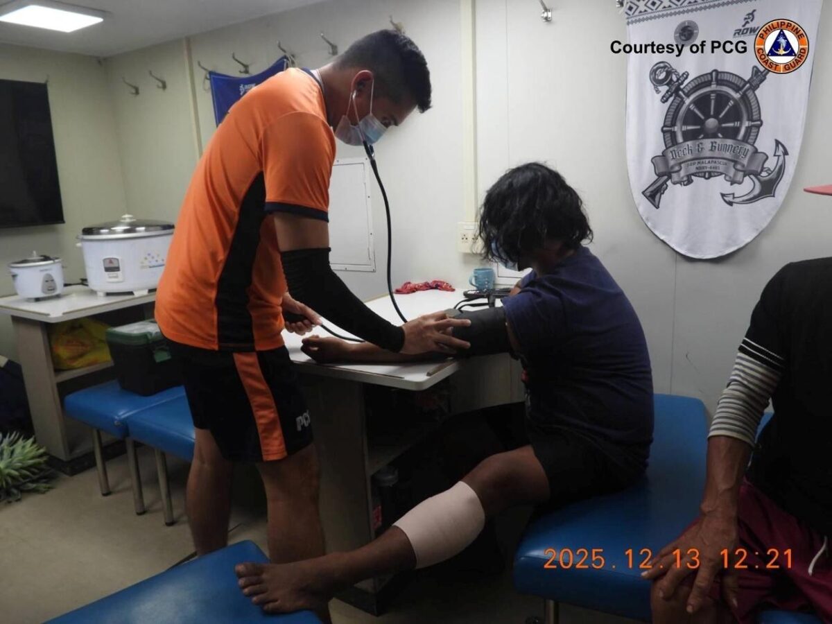 A Philippine Coast Guard personnel checks the vital signs of a rescued fisherman who was water-cannoned by the China Coast Guard in Escoda Shoal in the West Philippine Sea on December 13, 2025. — Photo from the Philippine Coast Guard