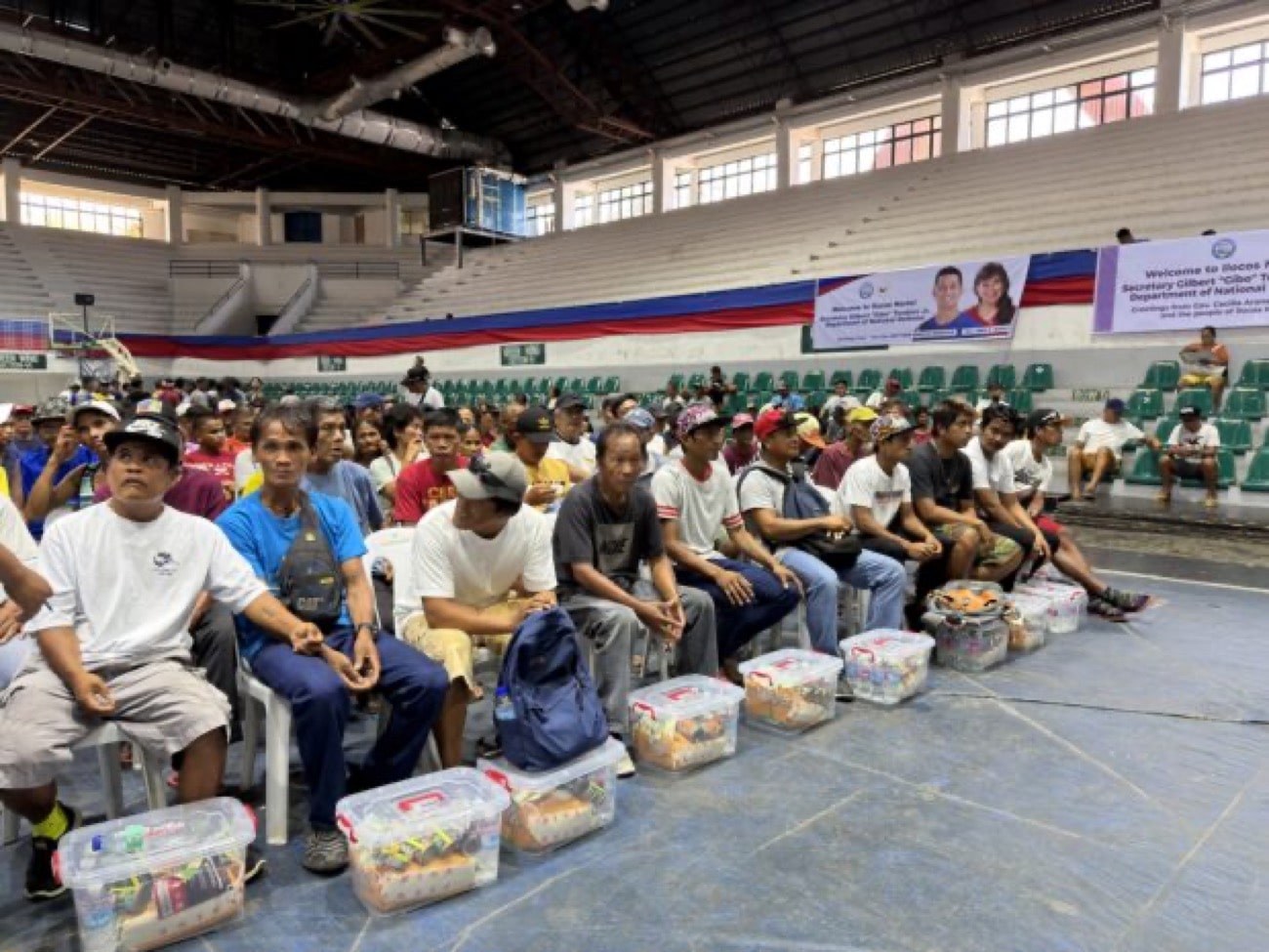 Fisherfolk receive cash aid and food packs in Laoag City, Ilocos Norte, on Saturday. (Photo by Gabryelle Dumalag)