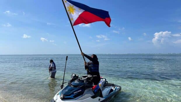 Lawmaker jet-skis to Sandy Cay, plants flag